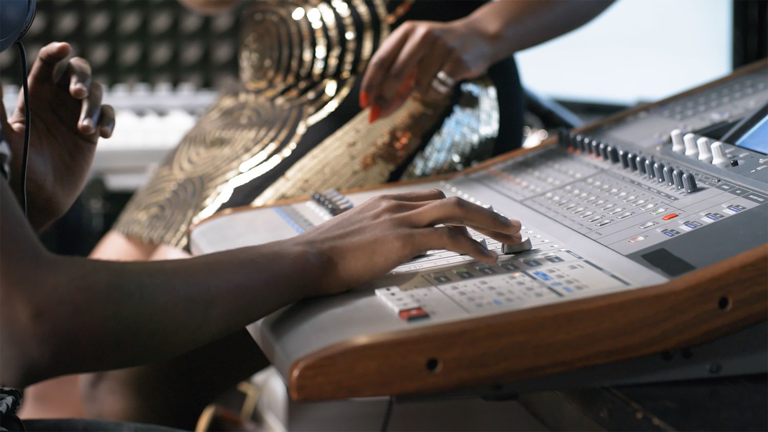 A producer shaping a recording session at the mixing board